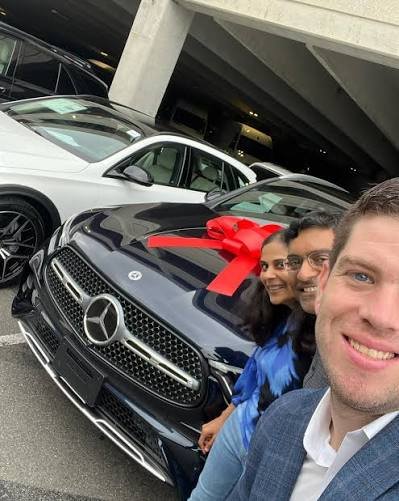 couple customers in car dealership showroom