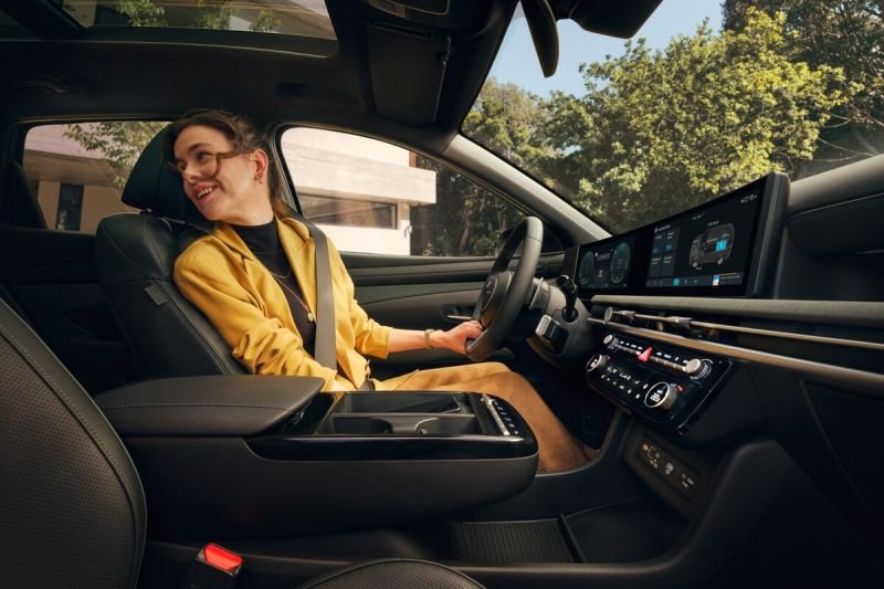Happy young female driver behind the wheel